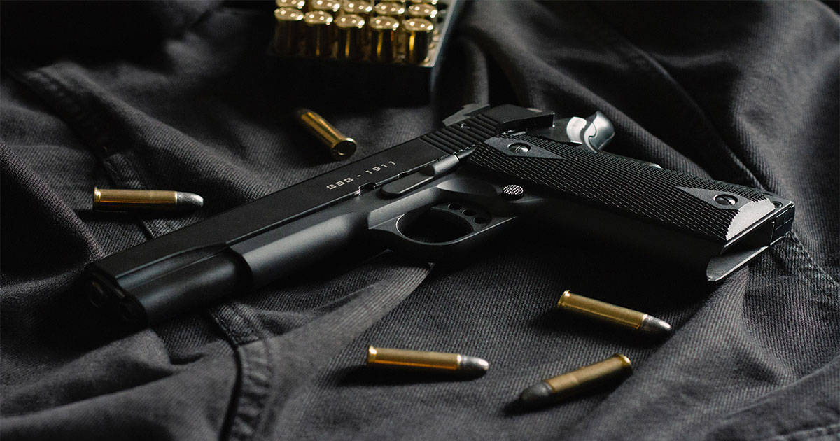 Black gun with gold bullets