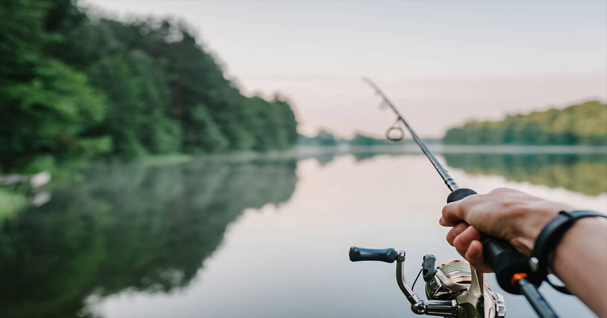 Hand casting fishing line into water