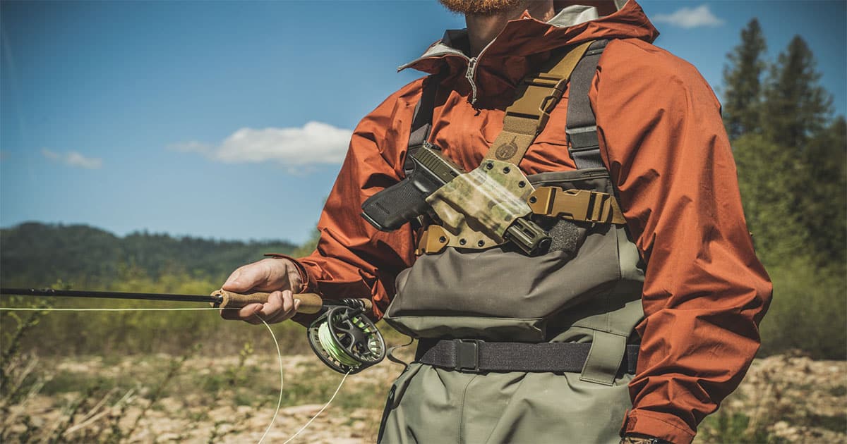 Man with fishing rod and gun in holster