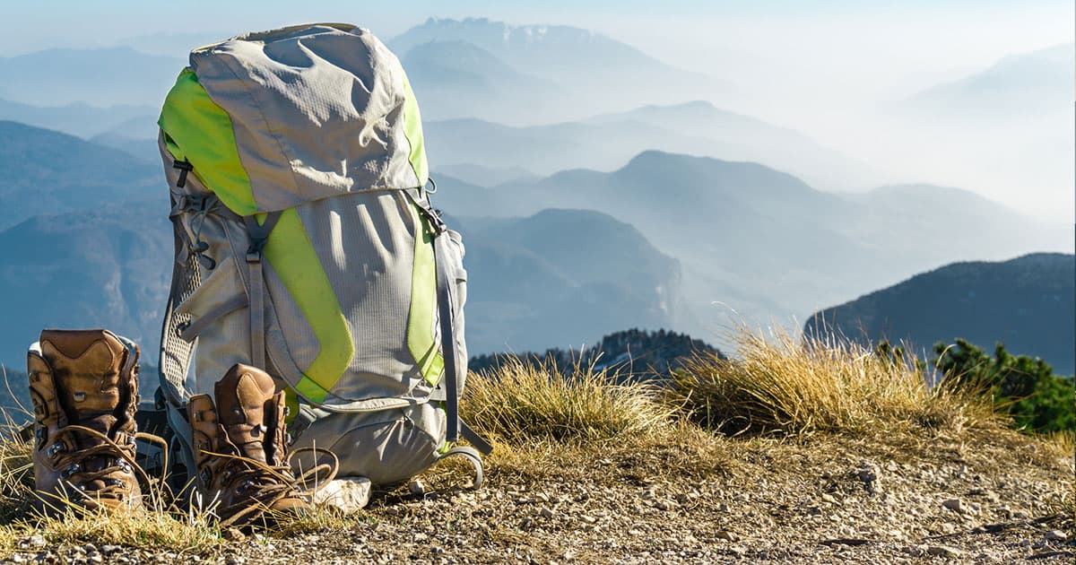 Backpack in nature with mountain background