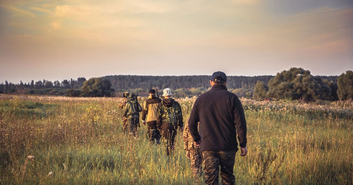 Group of hunters walking in hunting area