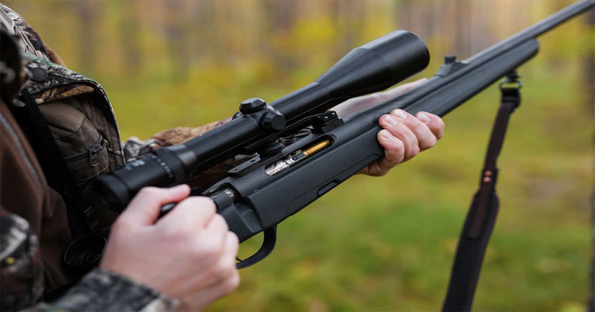 Man cocking gun with scope