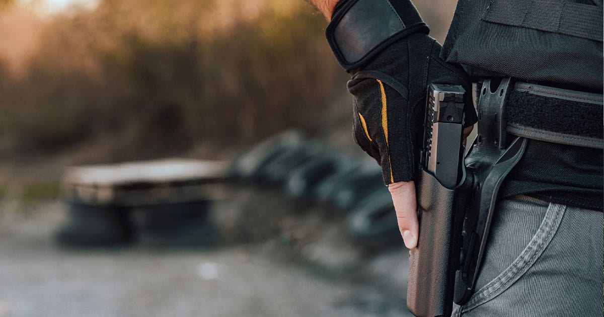 Man with hand on gun in holster