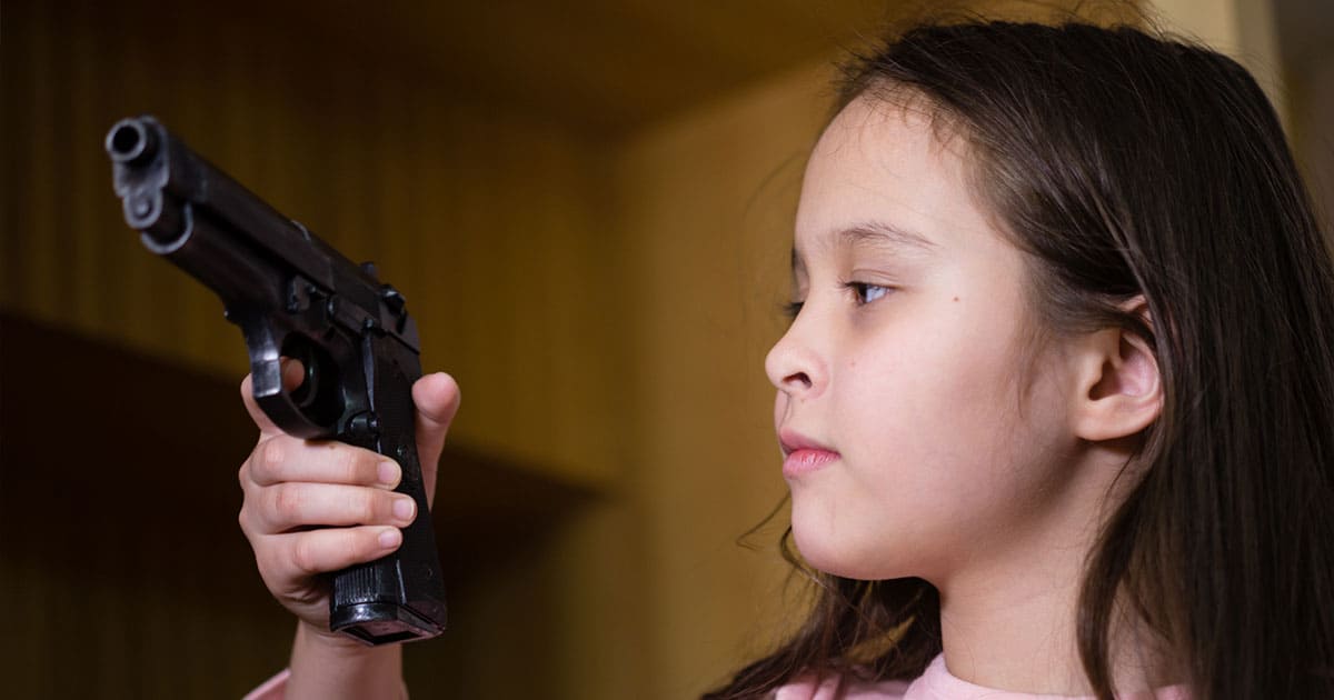 Child holding up gun