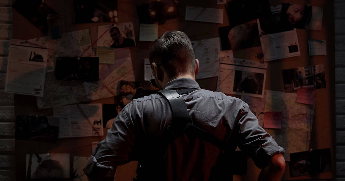 Man wearing holster looking at evidence