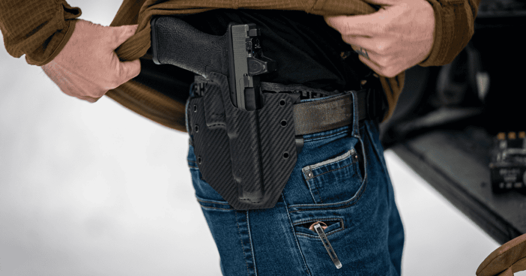 A man wearing an outside the waistband holster, Ronin by GunfightersINC.