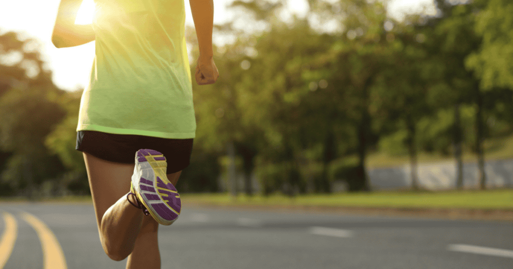 A woman in a yellow tank top running while concealed carrying.