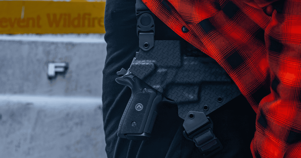 A man wearing the GunfightersINC Spectre Shoulder Holster under a red flannel.