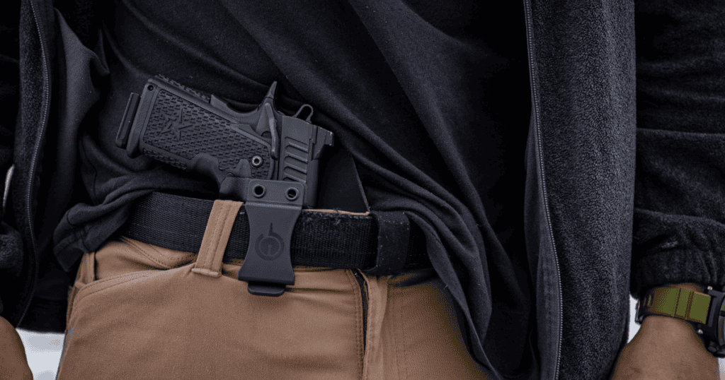 A man using the GunfightersINC Solace IWB Holster for concealed carry.