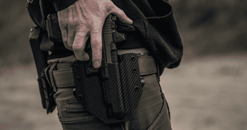 A man with his hand on his gun in his Ronin OWB Holster in black with a textured finish.