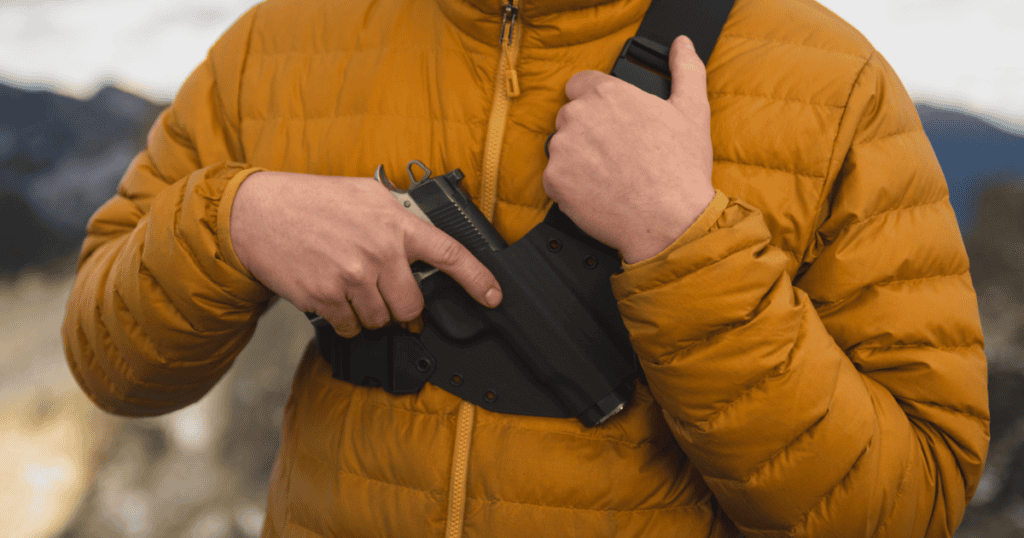 A man wearing a Kenai Chest Holster by GunfightersINC for his home defense holster.
