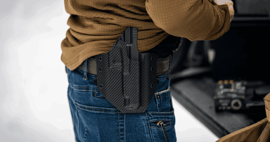 A man wearing a GunfightersINC Ronin OWB Holster in black.