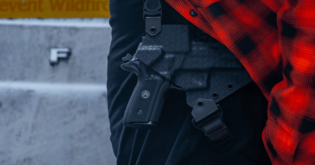 A man in a red flannel wearing a GunfightersINC Spectre Shoulder Holster.