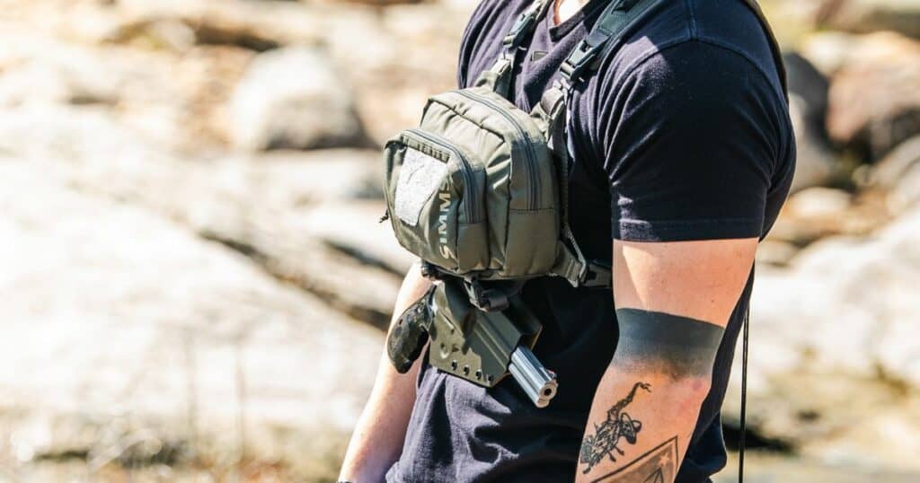 A man fishing wearing the Tackle-Link Holster by GunfighersINC.