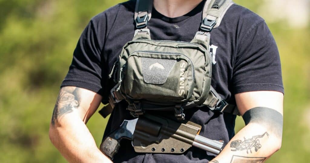A man fishing wearing a GunfightersINC Tackle-Link Holster.