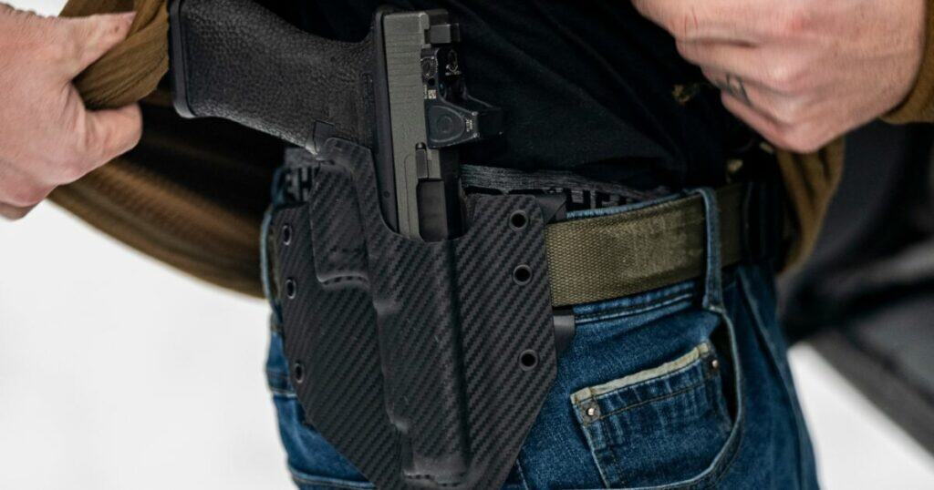A man wearing a Ronin GunfightersINC holster in black.