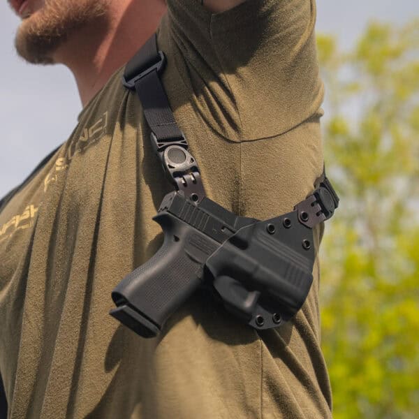 Man raising arm with a Spectre Lite containing a G43.