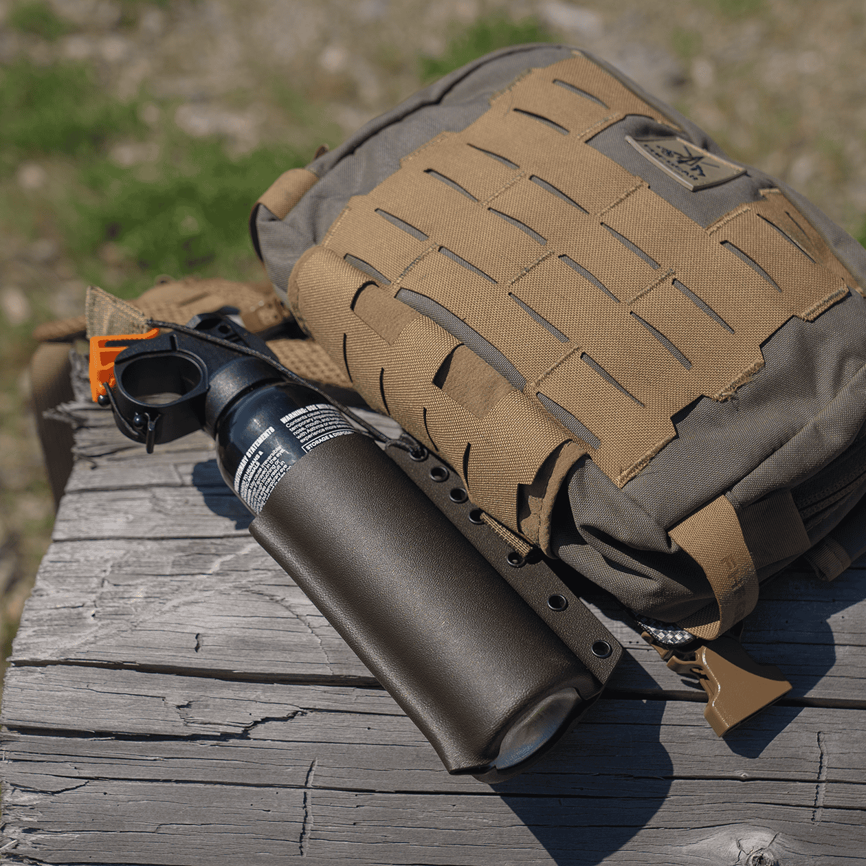 Bear-Link Attached to a Chest Pack and Sitting on a Log