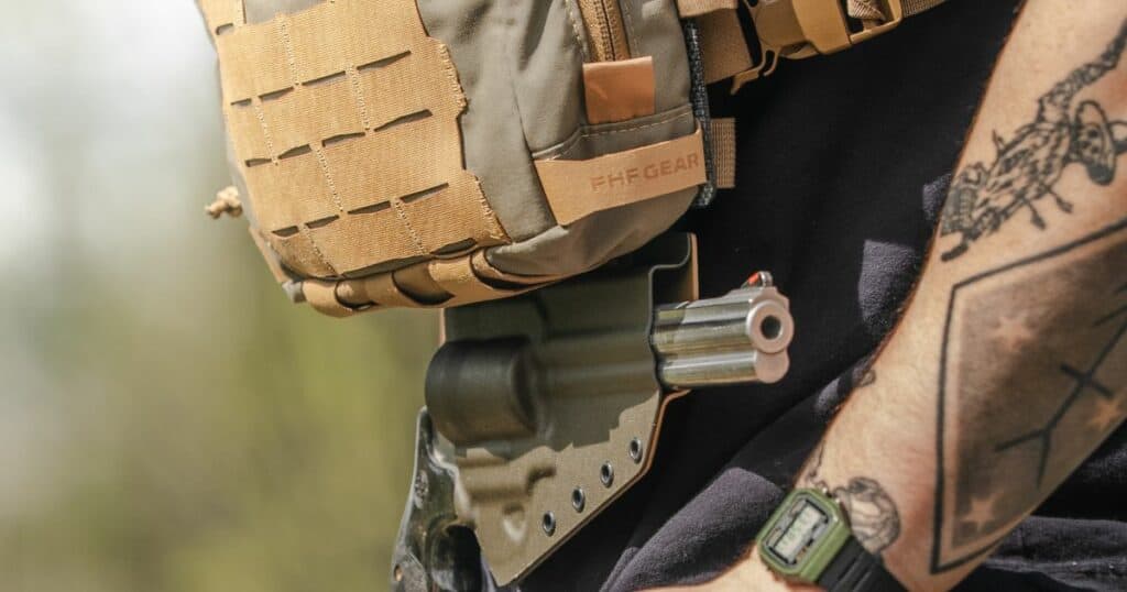 A man wearing a GunfightersINC Tackle-Link Holster while fishing.