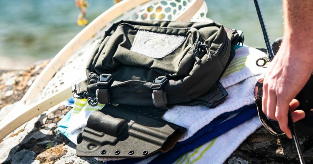 A GunfightersINC Bino Link Holster being used during fishing.