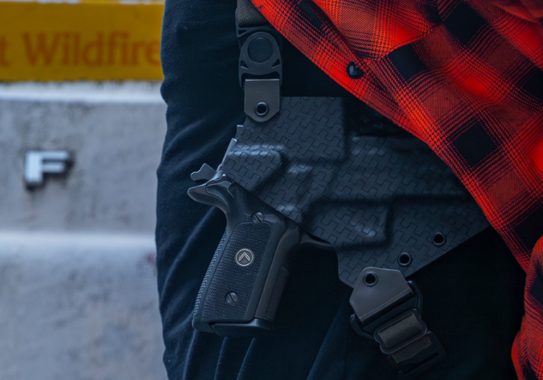 A man wearing the GunfightersINC Spectre Shoulder Holster under a red flannel.